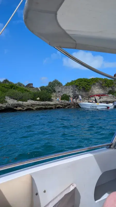Boat view of rocky coastline and turquoise water