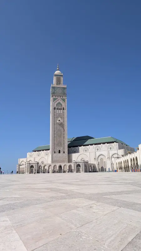 Hassan II Mosque courtyard under a clear blue sky